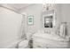 Bright bathroom with a tub, shower, marble sink, and a decorative mirror for a functional design at 448 Iverson Way, Charlotte, NC 28203