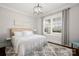 Bright bedroom featuring neutral decor, a large window, and a stylish chandelier at 448 Iverson Way, Charlotte, NC 28203