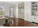 Light-filled dining room with hardwood floors, modern furnishings, and large windows at 448 Iverson Way, Charlotte, NC 28203