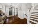 Elegant foyer with hardwood floors, staircase, and modern lighting fixtures, creating a grand entrance at 448 Iverson Way, Charlotte, NC 28203