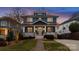 Charming two-story home featuring a welcoming porch with white columns and a landscaped front yard at 448 Iverson Way, Charlotte, NC 28203