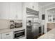 Bright kitchen features stainless steel appliances, white cabinets, and stone countertops at 448 Iverson Way, Charlotte, NC 28203