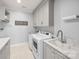 Well-lit laundry room features modern appliances, ample storage, and a convenient sink area at 448 Iverson Way, Charlotte, NC 28203