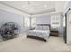 Spacious main bedroom features tray ceiling, a ceiling fan, two windows, and an accent wall at 448 Iverson Way, Charlotte, NC 28203