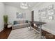 Home office area with modern desk, sofa, and lots of natural light at 448 Iverson Way, Charlotte, NC 28203