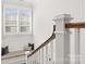 Staircase featuring a wood handrail, white trim, window, and a cozy built-in bench at 448 Iverson Way, Charlotte, NC 28203
