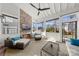 Inviting sunroom with brick fireplace, ceiling fan, and abundant natural light at 448 Iverson Way, Charlotte, NC 28203