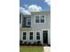 Close-up of gray townhome exterior with well-manicured lawn and inviting entryway at 4710 Lakeview Rd # Lot 10, Charlotte, NC 28216