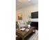 Comfortable living room with stylish decor, including a wood coffee table, modern artwork and large TV at 4710 Lakeview Rd # Lot 10, Charlotte, NC 28216