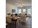 Open-concept living and dining area featuring hardwood floors and modern furnishings at 4710 Lakeview Rd # Lot 10, Charlotte, NC 28216