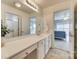 Bright bathroom features a large mirror, white cabinets, and a view into the bedroom at 6458 Chadwell Ct # 30, Indian Land, SC 29707