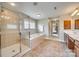 Well-lit bathroom featuring a glass shower, separate tub, and a view into the main bedroom at 6458 Chadwell Ct # 30, Indian Land, SC 29707