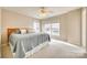 Bright bedroom with neutral walls and carpet has natural light from two windows at 6458 Chadwell Ct # 30, Indian Land, SC 29707