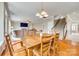 Open-concept dining area boasts wood floors, natural light and a view to the living room with fireplace at 6458 Chadwell Ct # 30, Indian Land, SC 29707