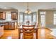 Open-concept dining area with wood floors, natural light and views of the gourmet kitchen at 6458 Chadwell Ct # 30, Indian Land, SC 29707