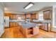 Gourmet kitchen with granite counters, stainless appliances, tile backsplash, wood floors, and large center island at 6458 Chadwell Ct # 30, Indian Land, SC 29707
