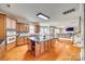 Gourmet kitchen with stainless appliances, center island, granite counters, tile backsplash, and wood flooring at 6458 Chadwell Ct # 30, Indian Land, SC 29707