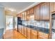 A modern kitchen with stainless steel appliances, wooden cabinets, and granite countertops at 6458 Chadwell Ct # 30, Indian Land, SC 29707