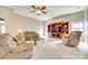 Living room featuring neutral walls and carpet, a ceiling fan, comfortable seating and built-in shelving at 6458 Chadwell Ct # 30, Indian Land, SC 29707