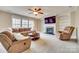 Inviting living room with fireplace, built-in shelving, plush seating, and ample natural light at 6458 Chadwell Ct # 30, Indian Land, SC 29707