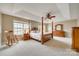 Comfortable bedroom with a four-poster bed, tray ceiling, and natural light from multiple windows at 6458 Chadwell Ct # 30, Indian Land, SC 29707