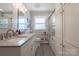 Modern bathroom featuring dual sinks, a spacious shower-tub, and a window for natural light at 662 University Dr, Rock Hill, SC 29730