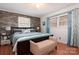 Comfortable bedroom featuring a wood accent wall, a ceiling fan, and natural light from the windows at 662 University Dr, Rock Hill, SC 29730