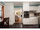 Bright kitchen featuring white cabinets, stainless steel oven, and dark wood flooring at 662 University Dr, Rock Hill, SC 29730