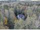 Aerial view of a charming home nestled among mature trees and greenery at 7512 Walkup Rd, Waxhaw, NC 28173