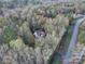 Aerial view of home nestled in a dense forest canopy at 7512 Walkup Rd, Waxhaw, NC 28173