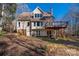 Back of house with a deck, brick accents, and a tree-covered lot at 7512 Walkup Rd, Waxhaw, NC 28173