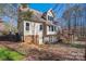 Back of house with deck, brick accents and tree covered lot at 7512 Walkup Rd, Waxhaw, NC 28173