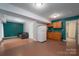 Basement with a partial kitchen with wooden cabinets and ample room for a living space at 7512 Walkup Rd, Waxhaw, NC 28173