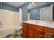Cozy bathroom with single vanity, shower-tub combo, and classic fixtures at 7512 Walkup Rd, Waxhaw, NC 28173