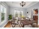 Bright dining room with hardwood floors, large windows, and an elegant chandelier is perfect for entertaining guests at 7512 Walkup Rd, Waxhaw, NC 28173