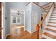 Elegant entryway with hardwood floors, staircase, and view into the dining room at 7512 Walkup Rd, Waxhaw, NC 28173