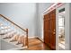 Inviting foyer with hardwood flooring, stairs, and a beautiful wood front door with sidelights at 7512 Walkup Rd, Waxhaw, NC 28173