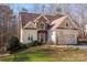 Charming home featuring a well-manicured lawn, brick accents, and an attached two-car garage at 7512 Walkup Rd, Waxhaw, NC 28173