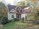Charming two-story home with brick and siding, a well-manicured lawn and established landscaping at 7512 Walkup Rd, Waxhaw, NC 28173