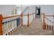 Bright hallway with white railings, carpeted floors, and natural light at 7512 Walkup Rd, Waxhaw, NC 28173