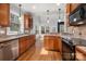 Bright kitchen with stainless steel appliances, wooden cabinets, and hardwood floors to create the perfect atmosphere at 7512 Walkup Rd, Waxhaw, NC 28173