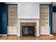Cozy living room featuring a fireplace, custom built-in shelving, and hardwood floors at 7512 Walkup Rd, Waxhaw, NC 28173