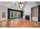 The open living room is enhanced by large windows, offering plenty of natural light and a fireplace to keep it warm at 7512 Walkup Rd, Waxhaw, NC 28173