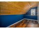 Unique room with wood paneled ceiling, blue accent wall, and hardwood floors at 7512 Walkup Rd, Waxhaw, NC 28173