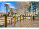 Wooden back deck features black metal railings and wooden posts, overlooking the backyard at 8670 Carroll St, Hickory, NC 28601