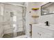 Bathroom with tiled shower with glass door, modern vanity and shelving at 8670 Carroll St, Hickory, NC 28601