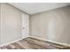 Cozy bedroom features light gray walls and wood-look flooring, door is white with black hardware at 8670 Carroll St, Hickory, NC 28601