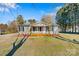 Inviting single-story home featuring a wooden porch, gray siding, and manicured front lawn at 8670 Carroll St, Hickory, NC 28601