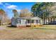 Charming single-story home with gray siding, black shutters, and a cozy front porch at 8670 Carroll St, Hickory, NC 28601