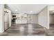 Open concept kitchen featuring stainless steel appliances, white cabinets and wood grain flooring at 8670 Carroll St, Hickory, NC 28601